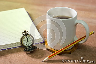 Black coffee with a notebook on a brown table. Stock Photo